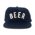 Navy blue cap with 'BEER' embroidered in white on a white background