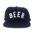 Navy blue cap with 'BEER' embroidered in white on a white background